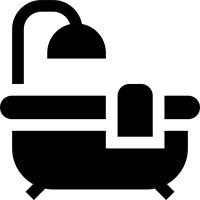 Silhouette of a bathtub with a showerhead and a towel draped over the side.